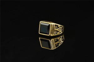 Detail of Masonic symbol engraving on gold-toned vintage men's ring with black stone