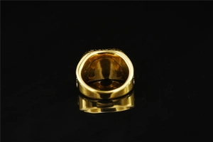 Detailed macro shot of a vintage gold Masonic ring with polished reflective surface