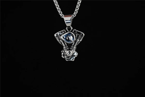 Macro detail of industrial punk motorcycle V-twin engine pendant on steel chain