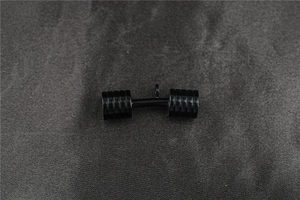 Detailed close-up of a solid black metal dumbbell pendant with a glossy finish