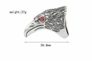 Macro side view of vintage eagle head ring with red zircon eyes and feather textures