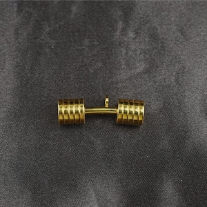 Polished golden dumbbell pendant necklace for men and women on gray textured background