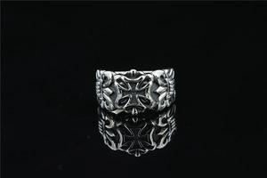 Macro shot of silver gothic ring showing hollowed carvings and maltese cross details