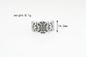 Macro shot of silver gothic iron cross ring showing detailed floral vine carvings