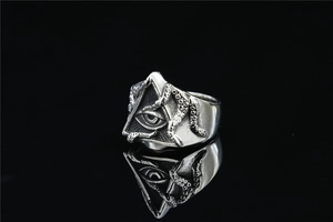 Macro detail of gothic octopus tentacle ring with embossed Eye of Horus in silver finish