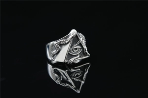 Macro shot of punk style silver octopus tentacle ring with Eye of Providence detail