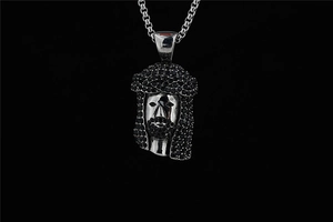 Macro shot of silver hip-hop Jesus pendant featuring iced out black micro-pavé diamonds
