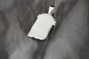 Detail of 925 silver Jesus pendant back with brushed metal finish and pave zircon rim