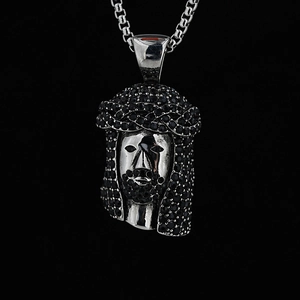 Hip hop Jesus piece pendant with black crystals and silver box chain on dark background
