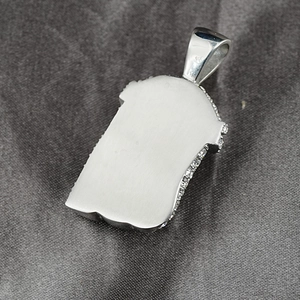 Brushed silver hip hop portrait pendant with side-set cubic zirconia on silk background