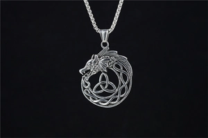 Detail of vintage Viking pterosaur pendant with celtic knot texture on steel chain