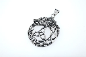 Detail shot of vintage Viking Ouroboros pendant with intricate Celtic Triquetra knot work