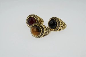 Detailed view of vintage titanium steel rings with tiger eye and obsidian gemstones