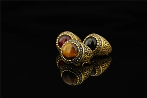 Detailed view of vintage gold rings with tiger eye and gemstones with baroque engraving