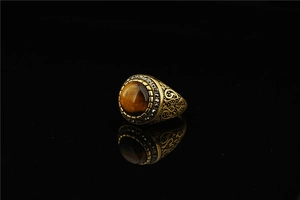 Detailed macro of vintage titanium steel ring with tiger eye stone and black crystal accents