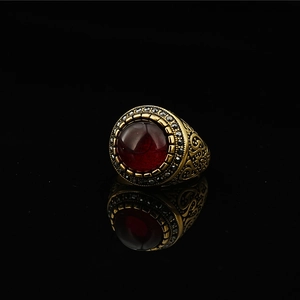 Vintage gold titanium steel ring with large red stone and black crystal accents