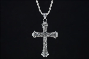 Detailed macro view of retro gothic stainless steel cross necklace with Jesus relief carving