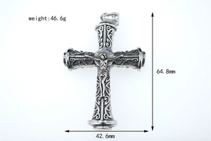 Macro view of vintage stainless steel cross pendant with baroque texture and dimensions