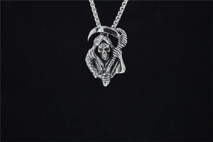 Macro view of detailed stainless steel grim reaper pendant with antique punk finish