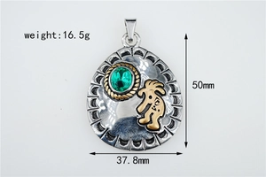 Detail of vintage silver pendant with green gemstone and Kokopelli totem, 50mm height