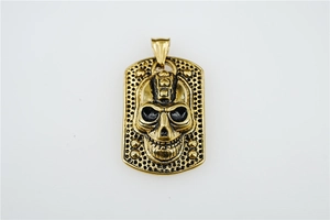 Macro detail of golden skull pendant with honeycomb texture and rivet decorations