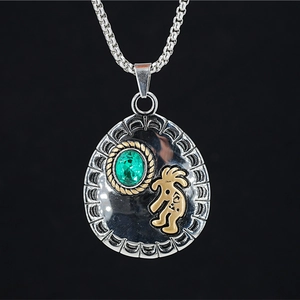 Ethnic teardrop silver necklace with green gemstone and golden Kokopelli symbol