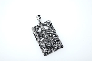 Macro detail of Guan Yu rectangle pendant with vintage dragon relief in steel