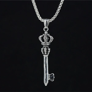 Retro silver crown key pendant necklace with sturdy box chain on dark background