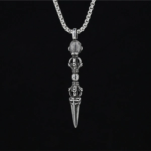 Vintage silver vajra pestle necklace for men featuring a bold braided chain on black background