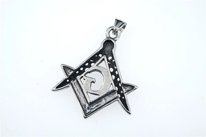 Macro detail of vintage Masonic pendant with compass design and aged silver finish