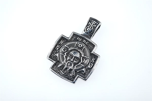 Detailed macro view of retro stainless steel crucifix pendant with Jesus relief carving