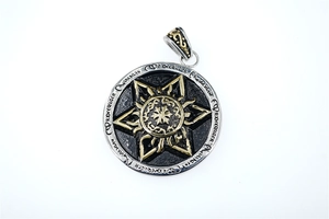 Detail of silver and gold round hexagram pendant with gothic runes and intricate carvings