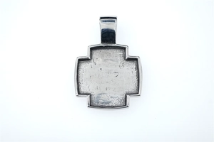 Detailed macro view of a hammered vintage stainless steel cross pendant for men
