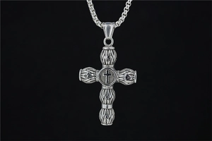 Detailed macro view of retro vintage cross pendant with oxidized silver finish and box chain