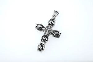 Detailed close-up of Gothic silver cross pendant with vintage engraved scrolls