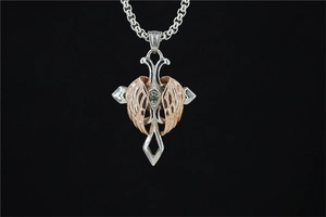 Macro view of cross necklace with rose gold wings and central cubic zirconia stone