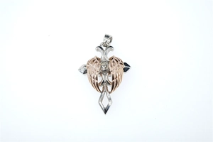 Detailed view of silver and rose gold cross pendant with feathered wings and zircon