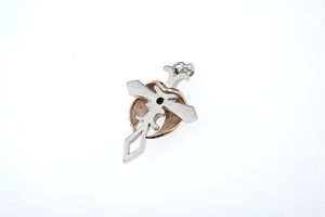 Close-up of dual-tone cross and heart pendant with matte texture and black center stone