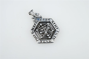 Macro detail of vintage hex Viking pendant showing intricate Nordic rune engravings