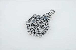 Detailed macro view of vintage hexagonal Viking compass pendant with engraved runes