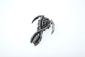 Detail view of retro stainless steel reaper skull pendant with double scythes and gothic texture