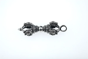 Detailed view of vintage silver Dorje Vajra pendant with intricate ethnic carvings