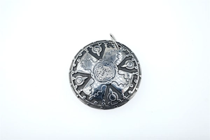 Detail view of round vintage silver shield pendant with Psalm 28 7 engraving