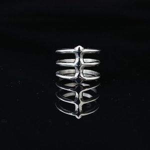 Gothic style triple-layer silver spine ring with polished finish on black background