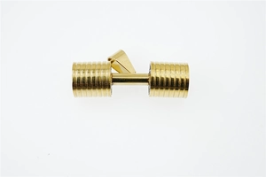 Macro shot of a golden dumbbell pendant with fine grooves and polished metallic finish