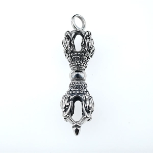 Vintage silver Buddhist Vajra Dorje pendant with intricate lotus patterns on white background