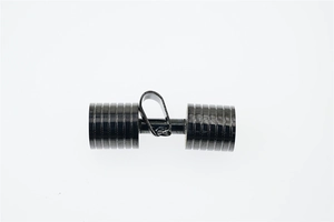 Detailed macro shot of a black dumbbell-shaped pendant with a metallic polished finish