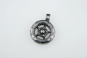 Detail of vintage hollow tire pendant in titanium steel with black oxidized finish
