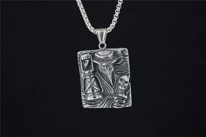Macro view of gothic plague doctor relief on silver rectangular pendant with box chain