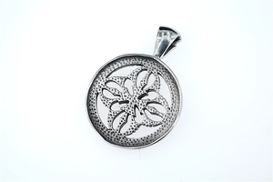 Macro detail of vintage hollow cross floral pendant with distressed titanium steel finish